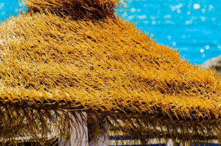 Beautiful sandy beach with umbrellas and blue sea background, vacation conceptの写真素材