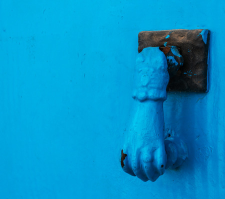 Door with brass knocker in the shape of a hand,  beautiful entrance to the house, vintage decorationの写真素材