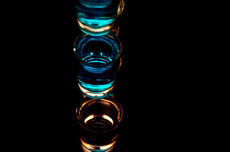 Popular drink shot kamikaze based on vodka, blue curacao and lemon juice, refreshing drink, party nightの写真素材