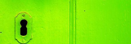 Keyhole in an old door with an interesting texture, a remnant of an old entrance security, vintage