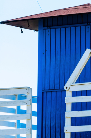 Blue rescue hut on a sandy beach, safe relax by the ocean, a beautiful sunny day, vacationの写真素材