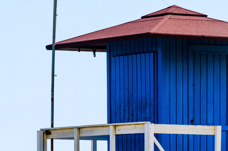 Blue rescue hut on a sandy beach, safe relax by the ocean, a beautiful sunny day, vacationの写真素材
