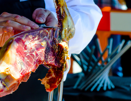 Professional chef slicing jamon serrano, traditional Spanish ham, meatの写真素材