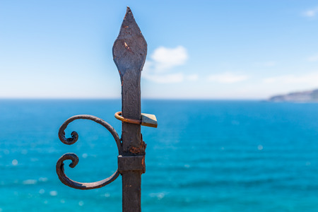 Rusty padlock attached to a balustrade by the sea, a traditional way of showing love, relationshipの写真素材