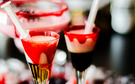 Creepy Halloween party cocktails with spider and syringes of grenadine syrup as blood, shot drinks at party, scary barの写真素材