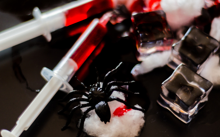 Creepy Halloween party cocktails with blood, spiders and ice cubes, drinks at partyの写真素材