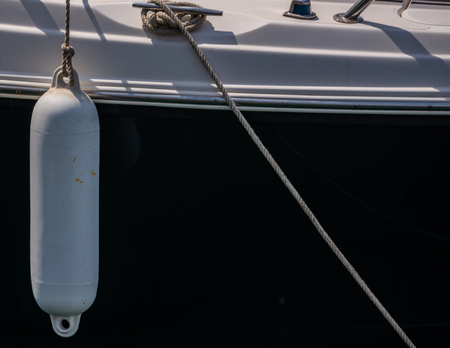 Buoy hanging outside the hull of the boat, boat equipment, safety at seaの写真素材