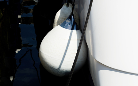 Buoy hanging outside the hull of the boat, boat equipment, safety at seaの写真素材