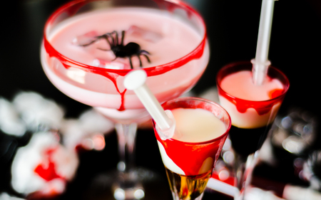 Creepy Halloween party cocktails with blood, spiders and ice cubes, drinks at partyの写真素材