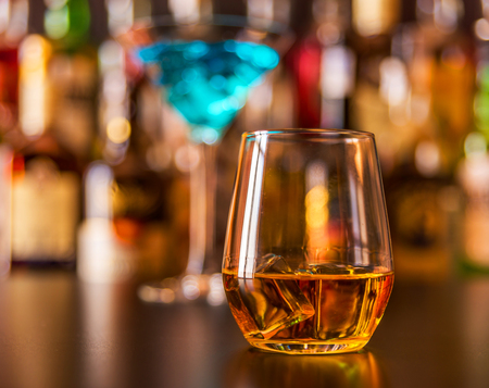 Scottish whisky in a glass with ice cubes, golden color whiskey, exclusive drinkの写真素材
