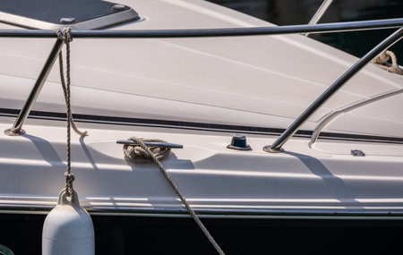 Dock cleat on the side of a boat in a small marina, an element of yachting equipment, safety