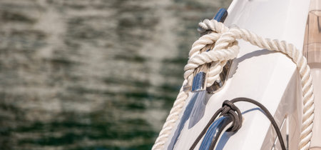 Dock cleat on the side of a boat in a small marina, an element of yachting equipment, safety