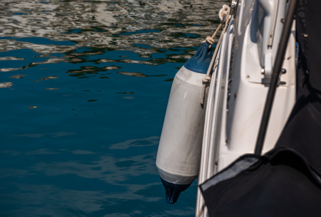 Buoy hanging outside the hull of the boat, boat equipment, safety at seaの写真素材