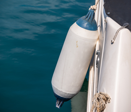 Buoy hanging outside the hull of the boat, boat equipment, safety at seaの写真素材