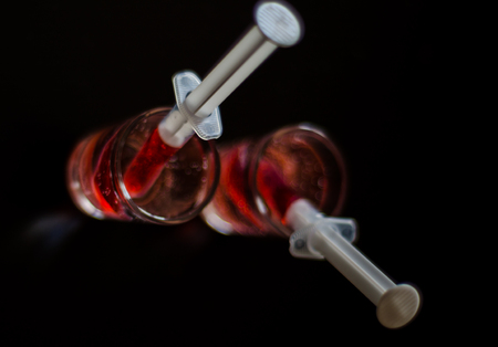 Creepy Halloween party cocktails with syringes of grenadine syrup as blood, shot drinks at party, scary barの写真素材