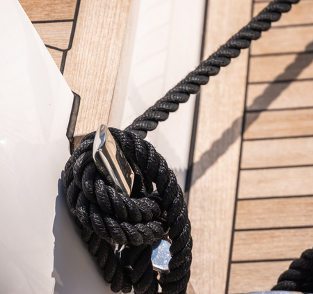 Dock cleat on the side of a boat in a small marina, an element of yachting equipment, safetyの写真素材