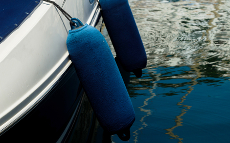 Buoy hanging outside the hull of the boat, boat equipment, safety at seaの写真素材