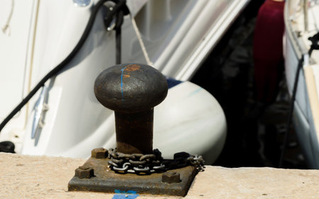 Mooring post on the waterfront in a small marina, element for mooring ships in the harbor, safety