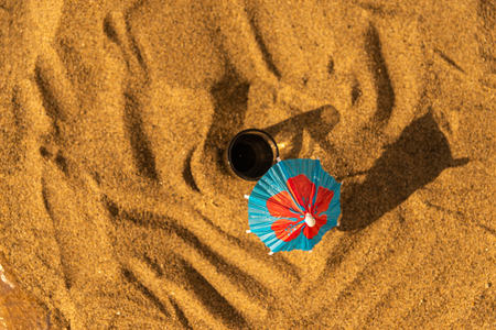 Colorful shots drinks on a sandy beach with umbrellas for drinks, summer relaxの写真素材