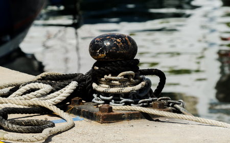 Mooring post on the waterfront in a small marina, element for mooring ships in the harbor, safetyの写真素材