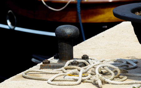 Mooring post on the waterfront in a small marina, element for mooring ships in the harbor, safety