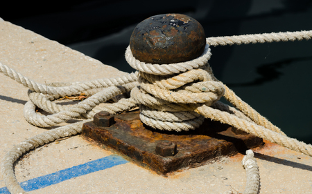 Mooring post on the waterfront in a small marina, element for mooring ships in the harbor, safetyの写真素材