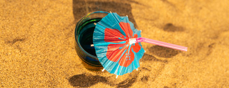 Colorful shots drinks on a sandy beach with umbrellas for drinks, summer relaxの写真素材