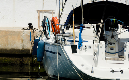Closeup on elements of yachts and motor boats anchored in the harbor, hot day at harbor, marinaの写真素材