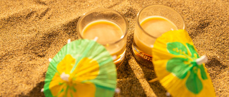 Colorful shots drinks on a sandy beach with umbrellas for drinks, summer relax