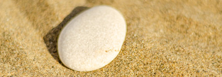 zen meditation stone in sand, concept for purity harmony and spirituality, spa wellness and yoga...