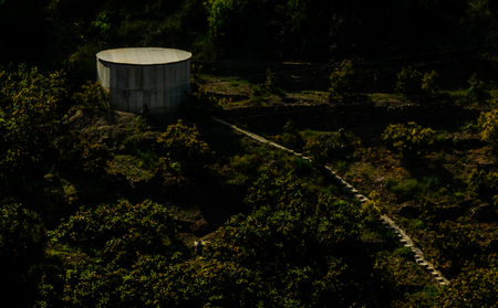 Concrete irrigation basin on high hills in Andalusia, a place of water storage in arid areas, agricultureの写真素材