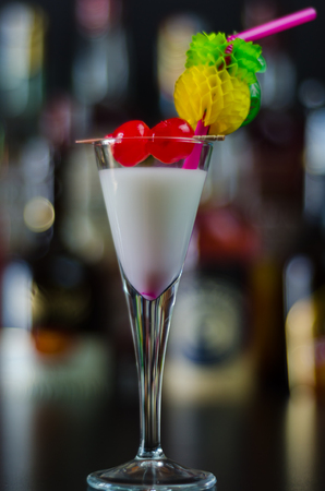 Exotic drink based on Malibu rum and other ingredients, cocktail prepared by the bartender, decorated drinkの写真素材