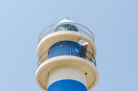 Lighthouse tower and blue summer sky, the safe return of the ship, maritime safety, high towerの写真素材