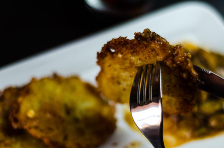 Potato pancakes with spicy stew, delicious traditional dish, Hungarian cuisine, tasty meal