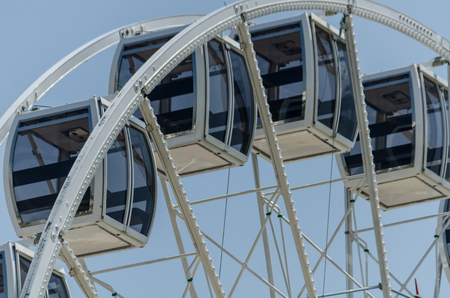 Big wheel in the seaside village, in the background clean blue sky, sunny dayの写真素材
