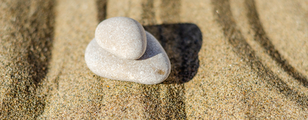 Zen meditation stone in sand, concept for purity harmony and spirituality, spa wellness and yoga background, harmonyの写真素材