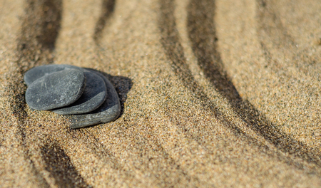Zen meditation stone in sand, concept for purity harmony and spirituality, spa wellness and yoga background, harmonyの写真素材