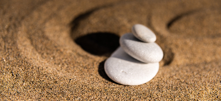 Zen meditation stone in sand, concept for purity harmony and spirituality, spa wellness and yoga background, harmonyの写真素材