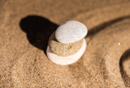 Zen meditation stone in sand, concept for purity harmony and spirituality, spa wellness and yoga background, harmonyの写真素材