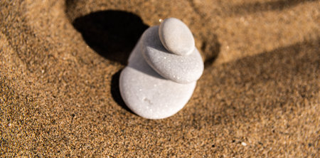 Zen meditation stone in sand, concept for purity harmony and spirituality, spa wellness and yoga background, harmonyの写真素材