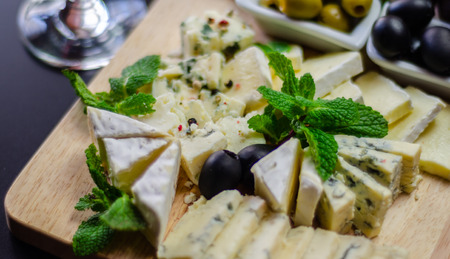 Set of different cheeses on a wooden board, cheese board, delicious snack, healthy and exclusive food, cheese setの写真素材