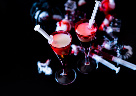 Creepy Halloween party cocktails with blood, spiders and ice cubes, drinks at partyの写真素材