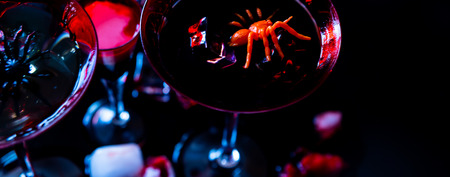 Creepy Halloween party cocktails with blood, spiders and ice cubes, drinks at partyの写真素材