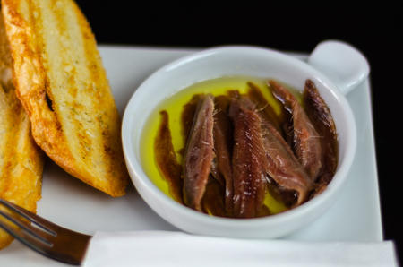 Delicious Spanish snack, fresh fish marinated in olive oil, served with croutons, seafood tapasの写真素材