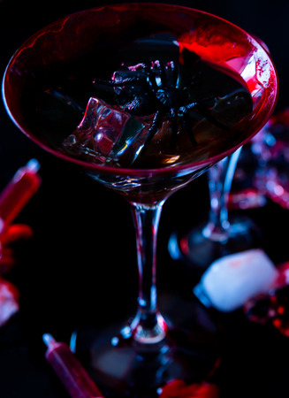 Creepy Halloween party cocktails with blood, spiders and ice cubes, drinks at partyの写真素材