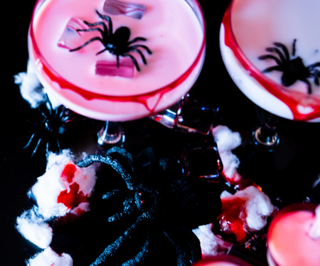 Creepy Halloween party cocktails with blood, spiders and ice cubes, drinks at partyの写真素材