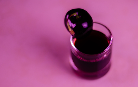 Cherry liqueur and juicy ripe cherries on the table in  the bar, an elegant serving of sweet drink in the restaurant, a traditional drinkの写真素材