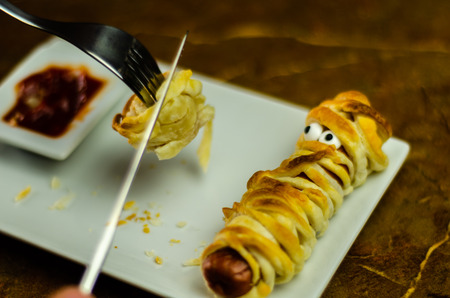 Sausage mummies in dough scary halloween food celebration party with funny eyes, food for kidsの写真素材