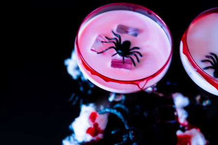 Creepy Halloween party cocktails with blood, spiders and ice cubes, drinks at partyの写真素材