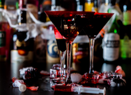 Creepy Halloween party cocktails with blood, spiders and ice cubes, drinks at partyの写真素材
